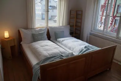 a bed sitting in a room with a window at Villa Donkey BnB in Degersheim