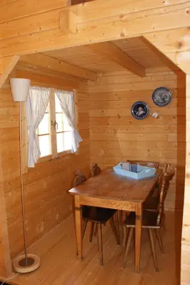 a wooden dining room with a wooden table and chairs at Villa Donkey Chalet in Degersheim