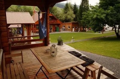 a wooden table on a porch of a cabin at Villa Donkey Chalet in Degersheim
