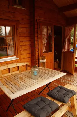 a wooden cabin with two pillows on a wooden deck at Villa Donkey Chalet in Degersheim