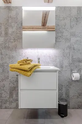 a bathroom with a white sink and a mirror at Dein Zuhause in Herisau in Herisau