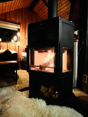 a stove with a fire in it in a room at Chalet - Kleines Paradies - in Appenzell
