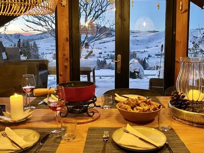 a wooden table with a table with a winter view at Chalet - Kleines Paradies - in Appenzell