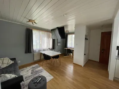 a living room with a couch and a table at Stockberghüsli in Nesslau