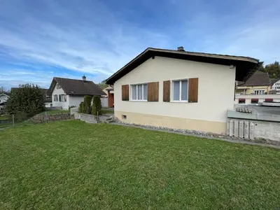 a house with a green lawn in front of it at Stockberghüsli in Nesslau