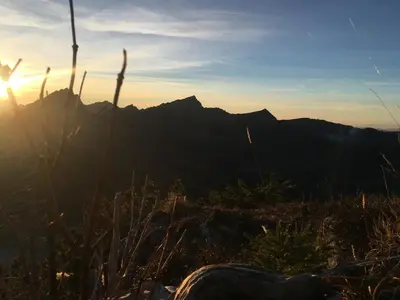 a view of the sun setting over the mountains at Stockberghüsli in Nesslau