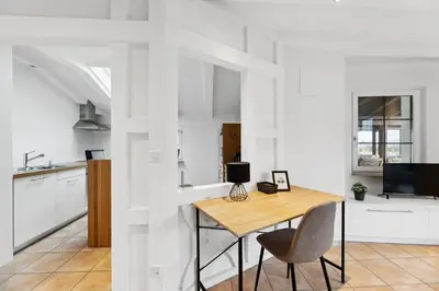 a kitchen and dining room with a table and chairs at Sonniges Apartment mit traumhaftem Bergblick in Buchs