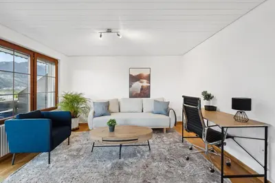 a living room with a couch and a table at Sonniges Apartment mit traumhaftem Bergblick in Buchs