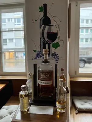 a bottle of wine and a glass on a table at tas24ch Travel and Sleep 24 in St. Gallen