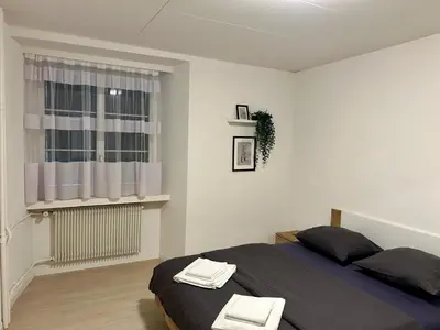 a bedroom with a bed and a window at tas24ch Travel and Sleep 24 in St. Gallen