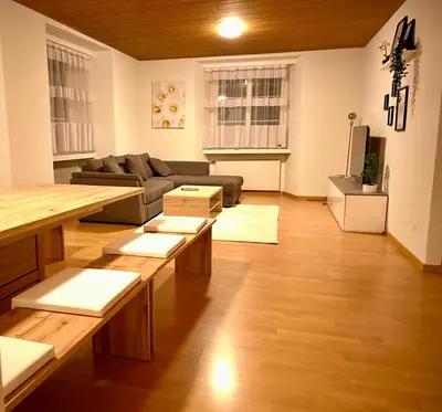 a living room with a couch and a table at tas24ch Travel and Sleep 24 in St. Gallen
