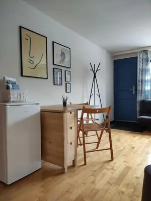 a kitchen with a desk and a chair and a refrigerator at Sonniges Studio mit Aussicht in Oberegg