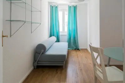 a room with a chair and a table and a window at Konstanz nähe, ruhiges 4-Zim-Wohnung bis 8 Personen in Kreuzlingen