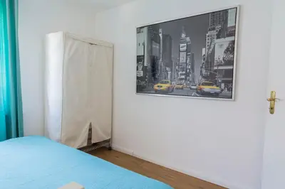 a bedroom with a bed and a picture on the wall at Konstanz nähe, ruhiges 4-Zim-Wohnung bis 8 Personen in Kreuzlingen