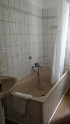 a bath tub with a faucet in a bathroom at Konstanz nähe, ruhiges 4-Zim-Wohnung bis 8 Personen in Kreuzlingen