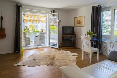 a living room with a couch and a tv at Konstanz nähe, ruhiges 4-Zim-Wohnung bis 8 Personen in Kreuzlingen