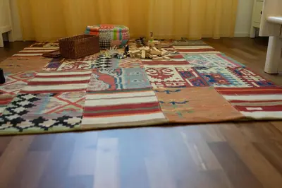 a large rug on the floor of a room at Rietgarten in Wildhaus