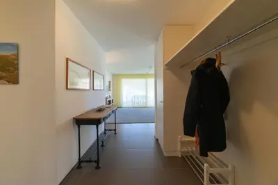 a hallway of a house with a desk and a hallway at Rietgarten in Wildhaus