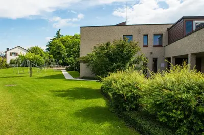a grassy yard next to a building at Jugendherberge Romanshorn in Romanshorn