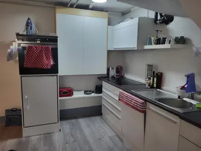 a small kitchen with white cabinets and a sink at Ahornwohnung, ruhige Lage, nähe Bahnhof und Zentrum in Buchs