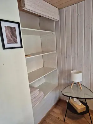 a walk in closet with a table and a lamp at Villa Donkey Ferienwohnung in Degersheim