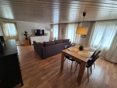 a living room with a table and a couch at Villa Donkey Ferienwohnung in Degersheim