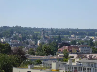 a group of people sitting at tables with umbrellas at Hotel SiX in Kreuzlingen