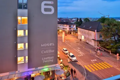 a cup of coffee and a croissant on a table at Hotel SiX in Kreuzlingen