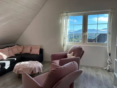 a living room with a couch and two chairs at Dachwhg an schöner Aussichtslage in Berneck