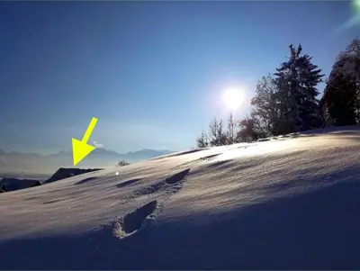 a snow covered hill with footprints in the snow at Dachwhg an schöner Aussichtslage in Berneck