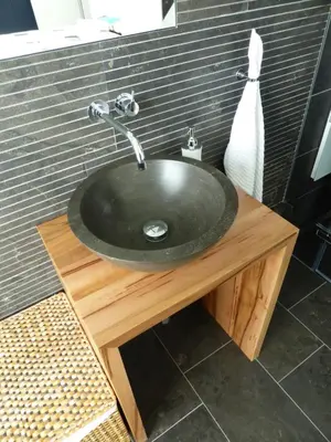 a bathroom sink on a wooden stand with a sink at Deluxe Zimmer in Privatwohnung an zentraler Lage in Teufen