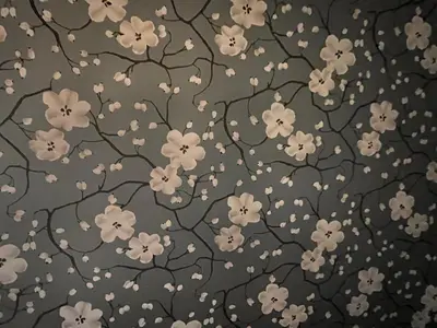 a pattern of white flowers on a gray background at Deluxe Zimmer in Privatwohnung an zentraler Lage in Teufen