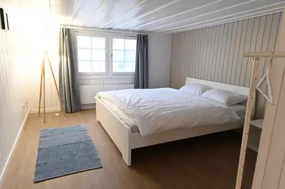 a bedroom with a white bed and a window at Alter Zoll in Teufen
