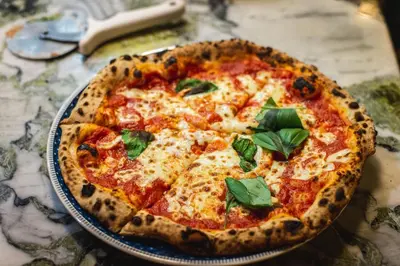 a pizza on a plate on a table at Alter Zoll in Teufen