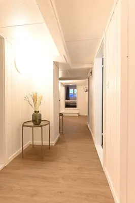 a hallway with a table and a vase on it at Alter Zoll in Teufen