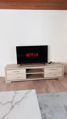 a tv sitting on top of a entertainment center at Cresta Apartment in St. Gallen
