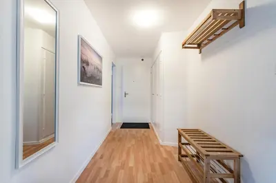 a hallway with white walls and a wooden bench at SOHO 13 !Gratis Parken, Free Parking! in Kreuzlingen