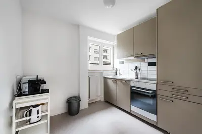 a kitchen with white cabinets and a counter top at SOHO 13 !Gratis Parken, Free Parking! in Kreuzlingen
