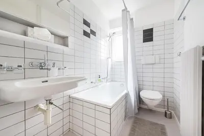 a white bathroom with a sink and a toilet at SOHO 13 !Gratis Parken, Free Parking! in Kreuzlingen