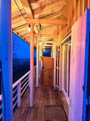 a porch of a house with a wooden ceiling at Haus am Seeufer mit Veranda in natürlicher Umgebung in Güttingen