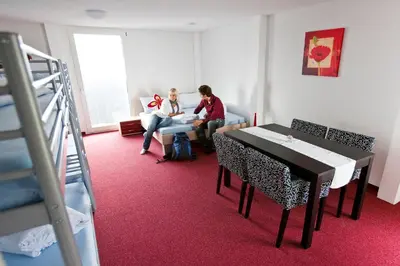 two women are sitting in a room with a table at Berggasthaus Oberdorf in Wildhaus
