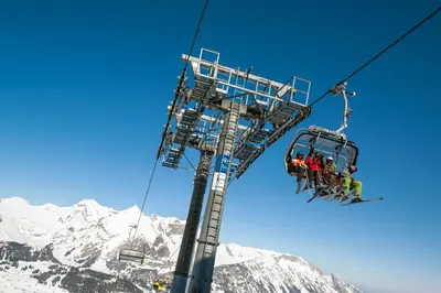 a group of people on a ski lift in the mountains at Berggasthaus Oberdorf in Wildhaus
