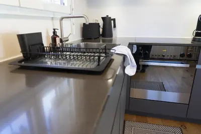 a kitchen with a dish drying rack on the counter at Gamsalpblick in Wildhaus