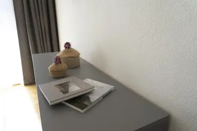 a table with a book and two knick knacks on it at Gamsalpblick in Wildhaus