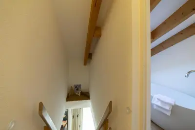 an attic bathroom with a sink and a mirror at Gamsalpblick in Wildhaus