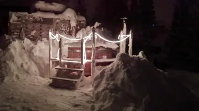 a small house covered in snow at night at Pilger-Hüttli - Blockhaus in Schönengrund