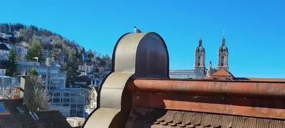 a view of a building with two towers in a city at Ruhige, neue Dachwohnung an Altstadt, nähe Messe in St. Gallen