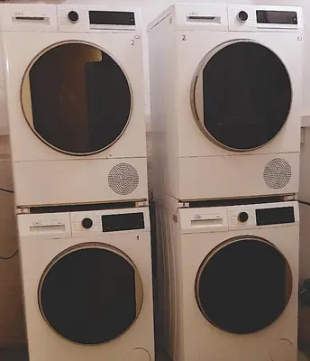 three washing machines sitting next to each other at Ruhige, neue Dachwohnung an Altstadt, nähe Messe in St. Gallen