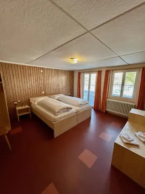 a bedroom with a large bed in a room at Gasthof Ochsen in Nesslau