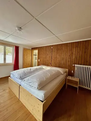 a bedroom with a large bed in a room at Gasthof Ochsen in Nesslau